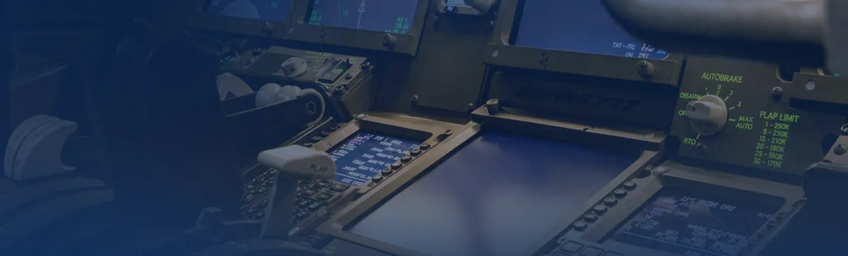 Pilot's hand on the thrust levers beside the flight deck displays